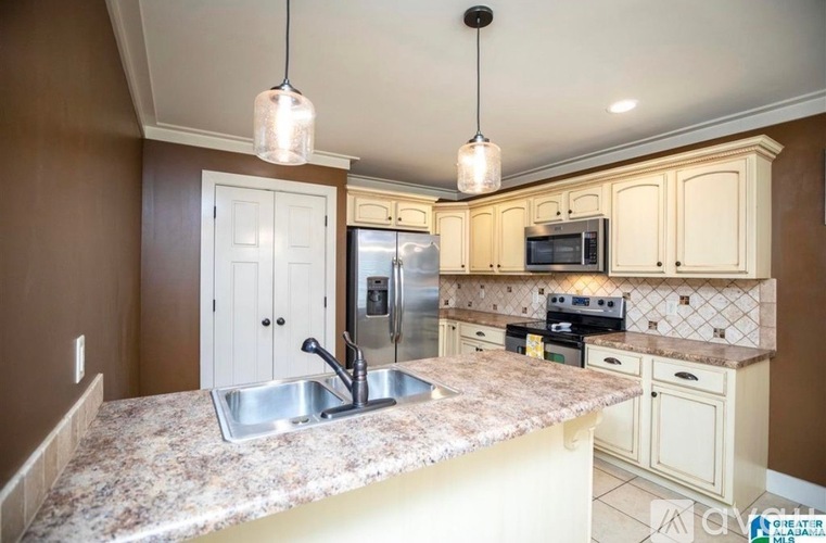 A kitchen with a granite countertop and a sink.