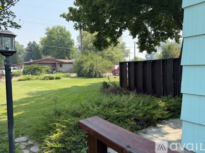 A backyard with a wooden fence and a lamp post.