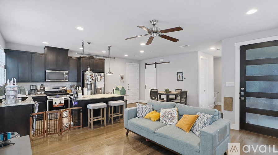 A modern kitchen with a dining area and a living room.