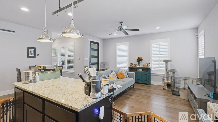 A kitchen with a counter and a fan.