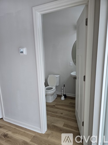 A white toilet is in a small bathroom.