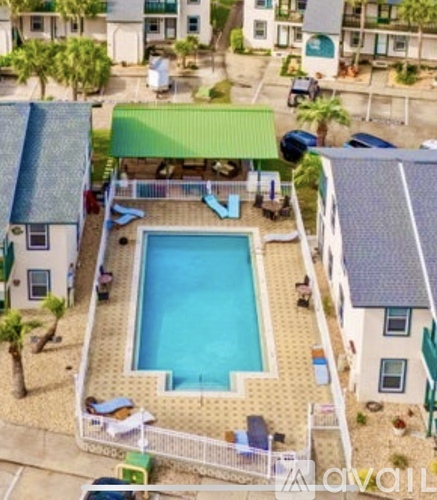 A pool surrounded by a fence and a green roofed structure.
