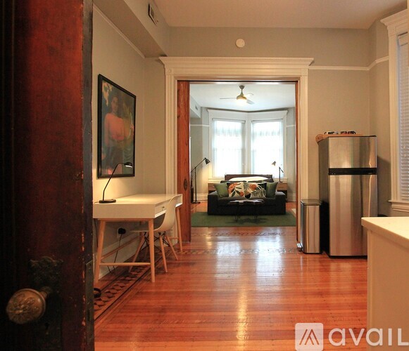 A living room with a couch, a chair, and a table.