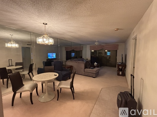 A living room with a white table and chairs.