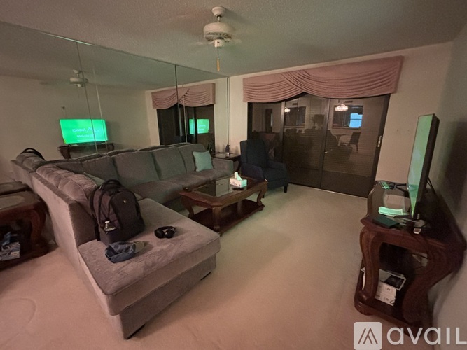 A living room with a grey couch and a television.