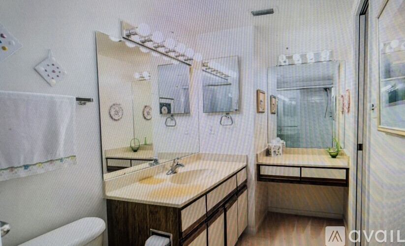 A bathroom with a sink, mirror, and toilet.