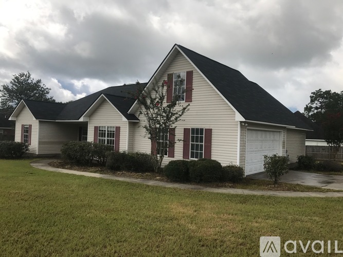 A house with a white exterior and a black roof is available for sale.