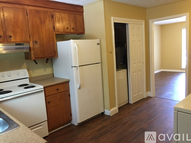 A kitchen with a white refrigerator and a white stove.