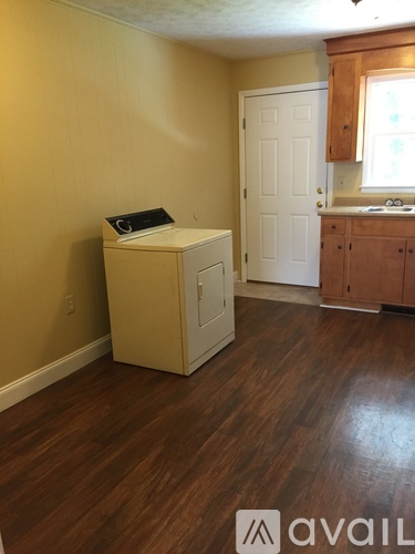 A room with wooden floors and a white cabinet.