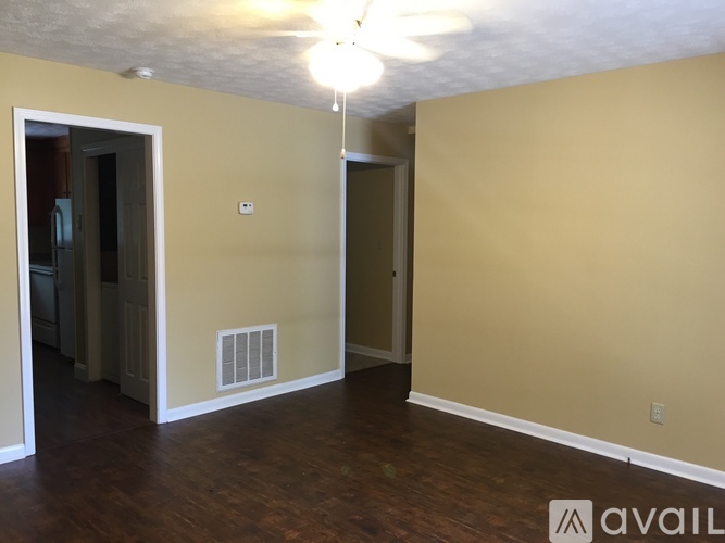 A room with a ceiling fan and a wall-mounted air conditioning unit.