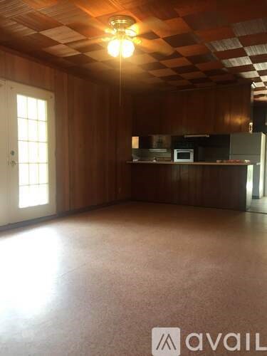 A room with wooden walls and a checkered ceiling.