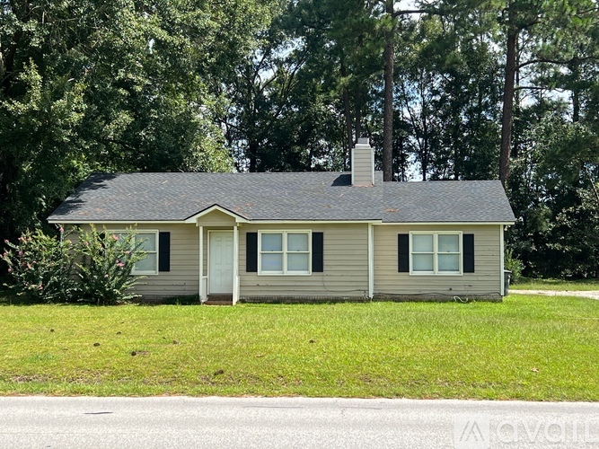 A small house with a grey roof and a white door.