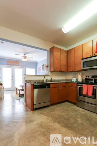 A kitchen with wooden cabinets and stainless steel appliances.