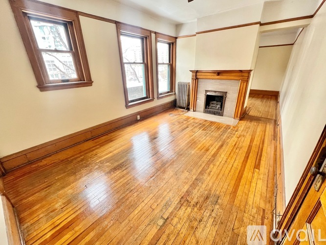 A room with wooden floors and a fireplace.