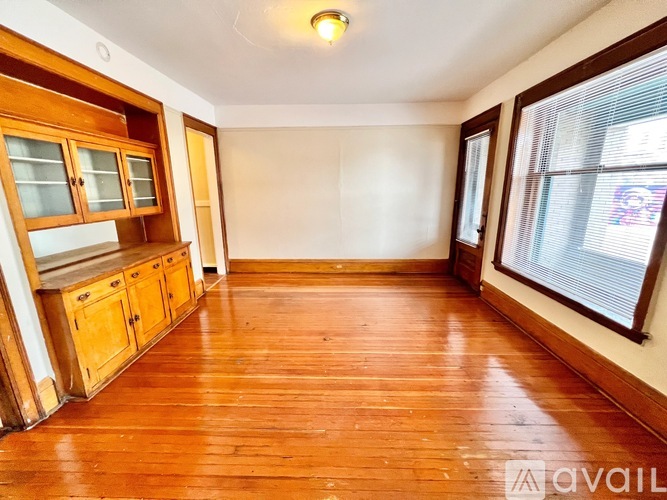 A room with wooden floors and cabinets.