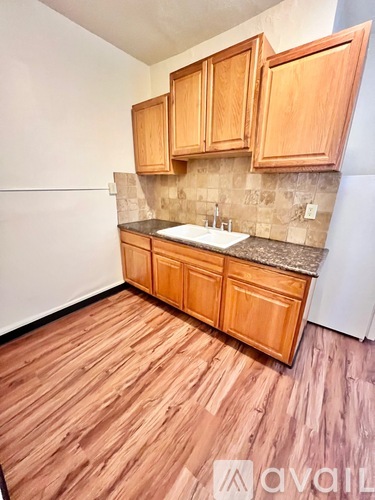 A kitchen with wooden cabinets and a countertop.