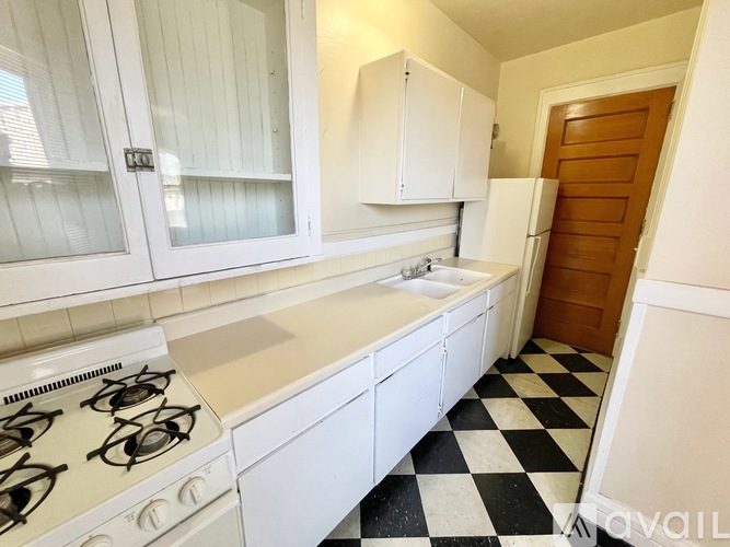 A kitchen with a black and white checkered floor.