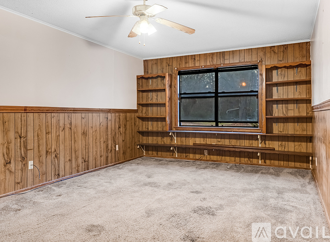 A room with wooden walls and a window.