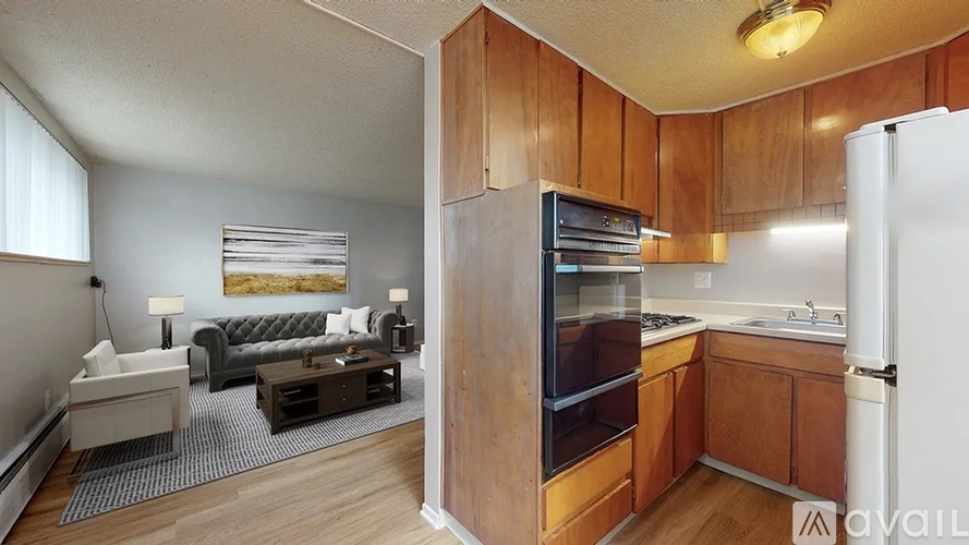 A kitchen with wooden cabinets and a refrigerator.