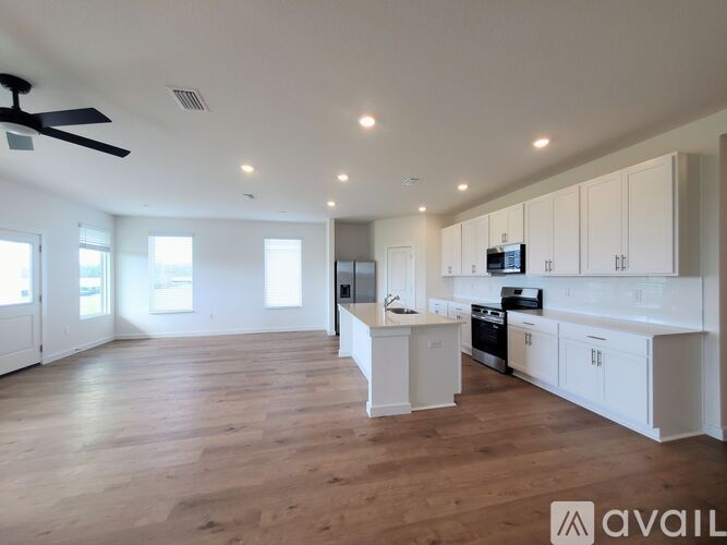 A white kitchen with a sink and a stove.