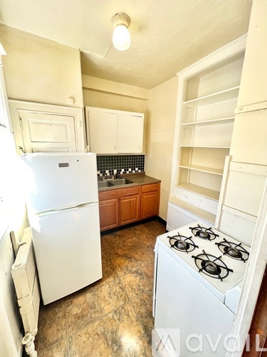 A kitchen with a white fridge and a white gas stove.