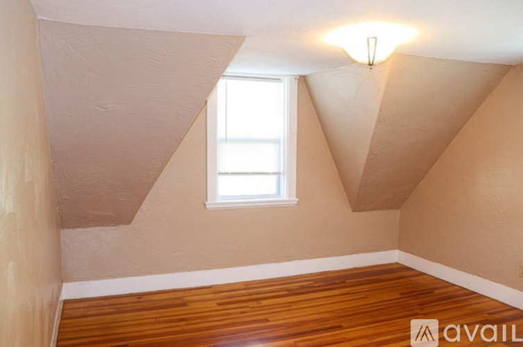 A room with wooden floors and a window.