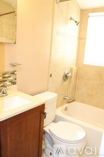 A bathroom with a toilet, sink, and bathtub.