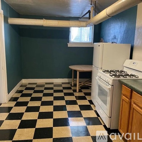A kitchen with a black and white checkered floor.