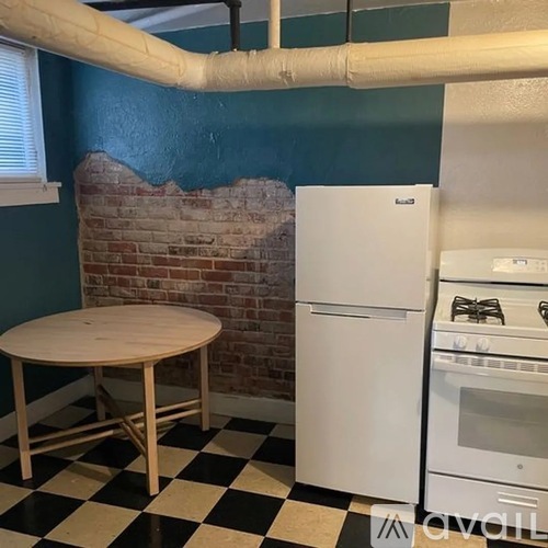 A kitchen with a white oven and a round table.