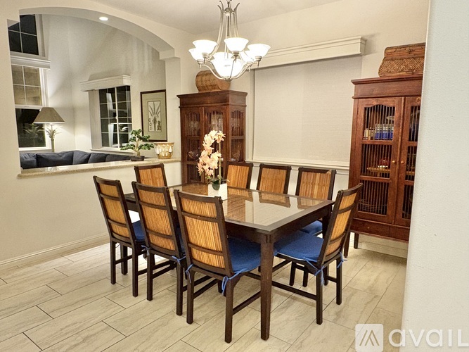 A dining room with a table set for six.