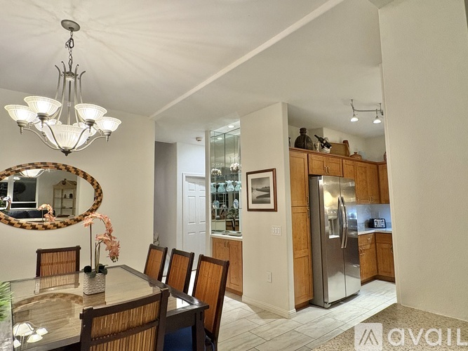 A modern kitchen with a dining table and chairs.