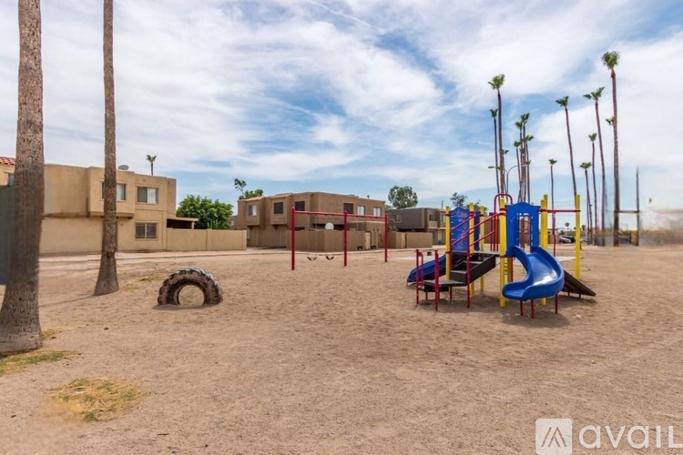A playground with a blue slide and a yellow structure.