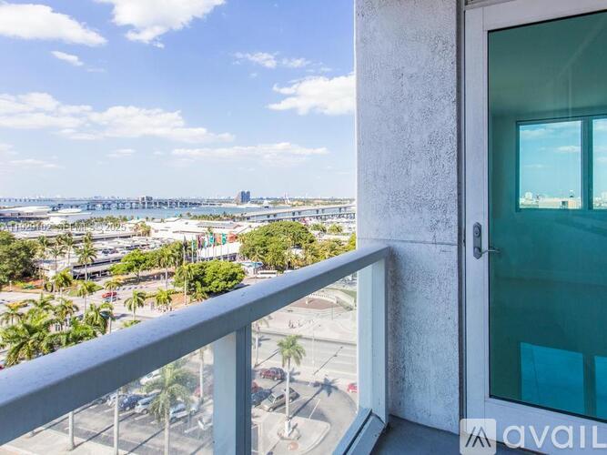A balcony with a view of a cityscape and a bridge.