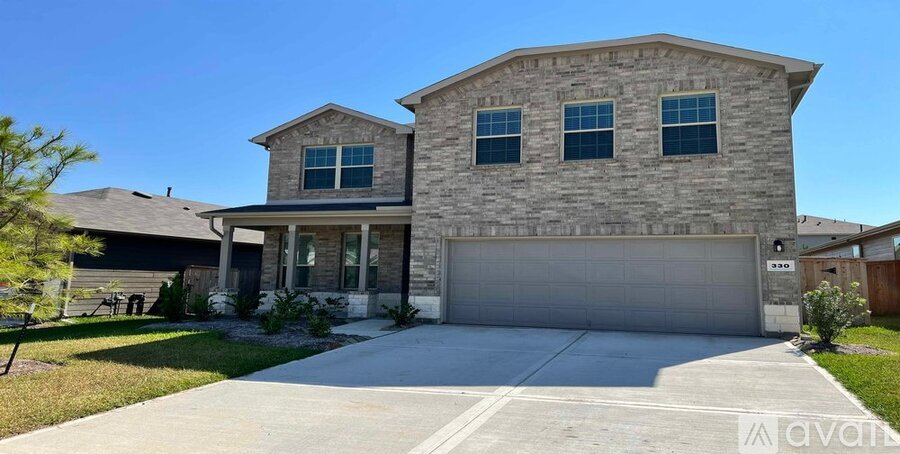 A house with a garage and a driveway in front.