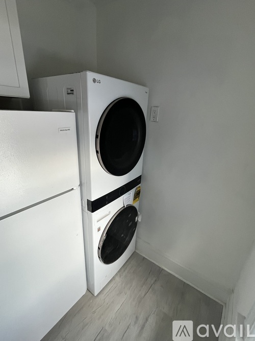 Two white LG washing machines in a small laundry room.