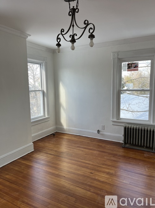 A room with wooden floors and a chandelier.