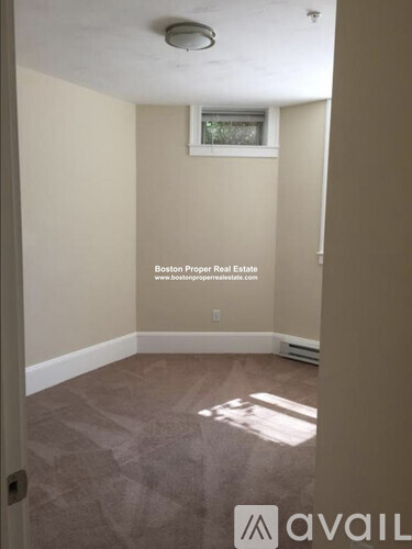 A room with a window and a tiled floor.