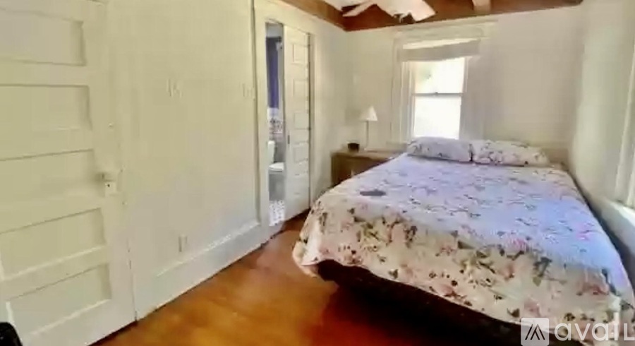 A bedroom with a bed and a dresser.