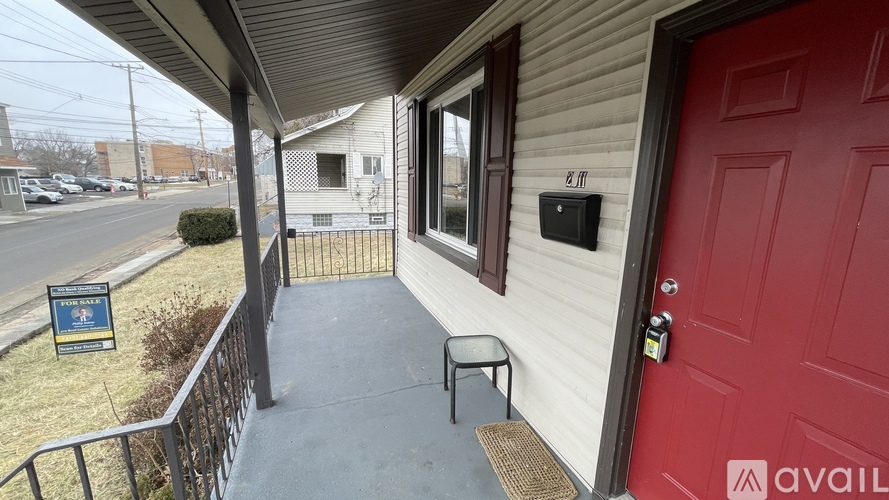 A house with a red door is for sale.