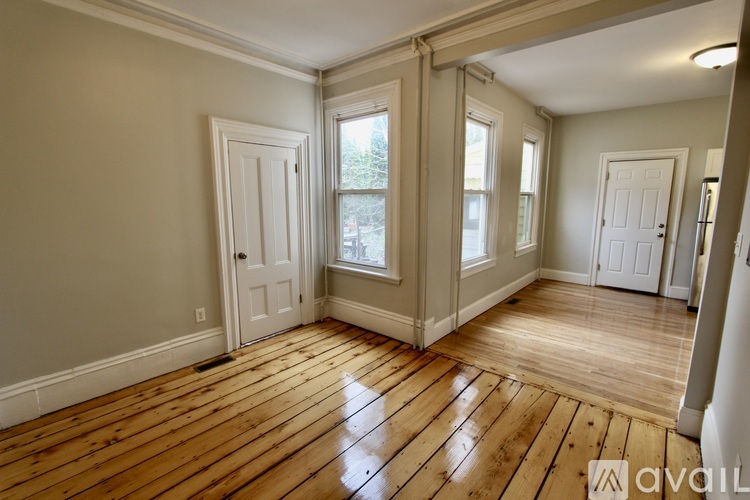 A room with wooden floors and white doors.