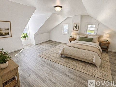 A kitchen with white cabinets and a window.