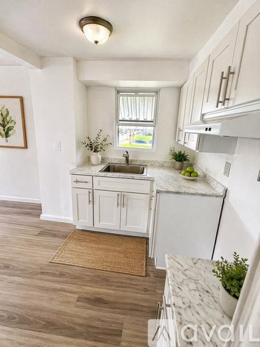 A room with wooden flooring and a window.