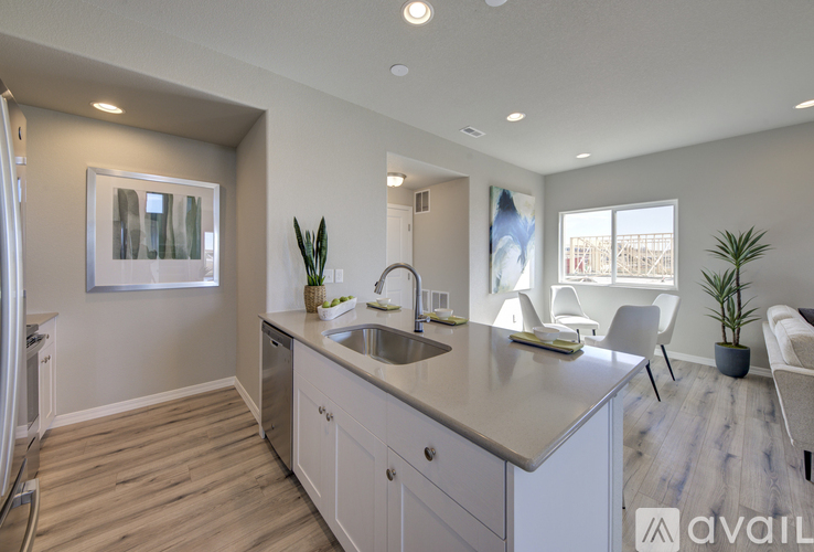 A modern kitchen with a large island and a view of the backyard.