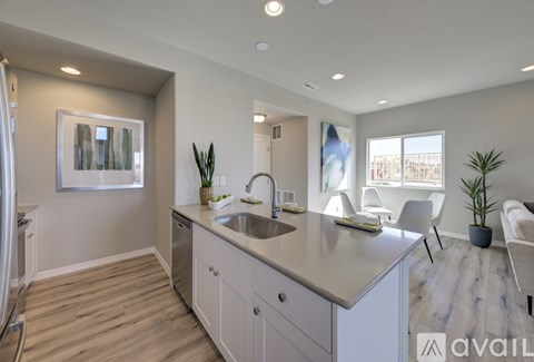 A modern kitchen with a large island and a view of the backyard.