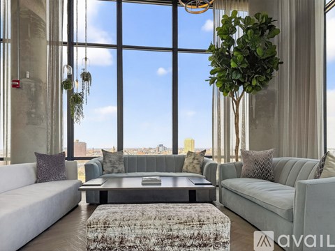 A living room with a large window overlooking the city.