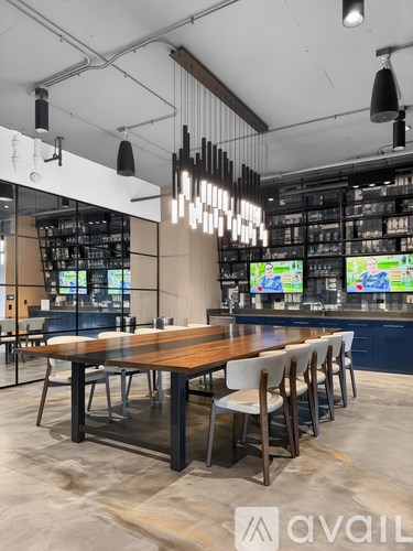 A modern dining area with a long table and chairs.