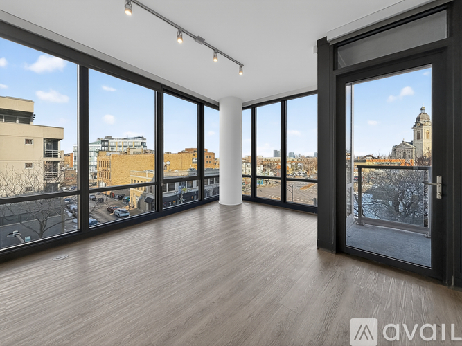 A spacious room with large windows overlooking a cityscape.