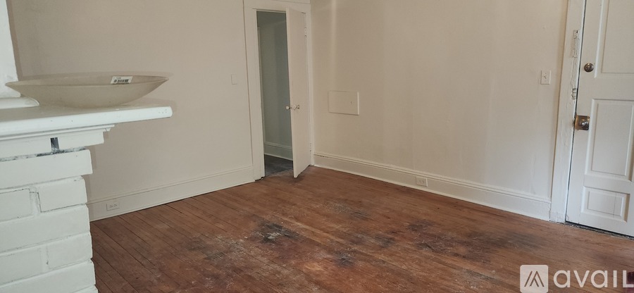 A room with a wooden floor and white walls.