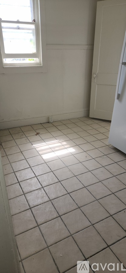 A room with white walls and a tiled floor.