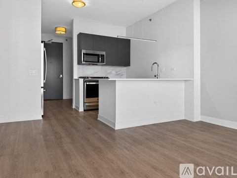 A kitchen with a white countertop and a microwave above it.